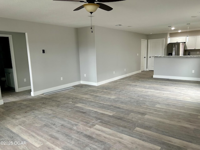 unfurnished living room with ceiling fan and light hardwood / wood-style flooring