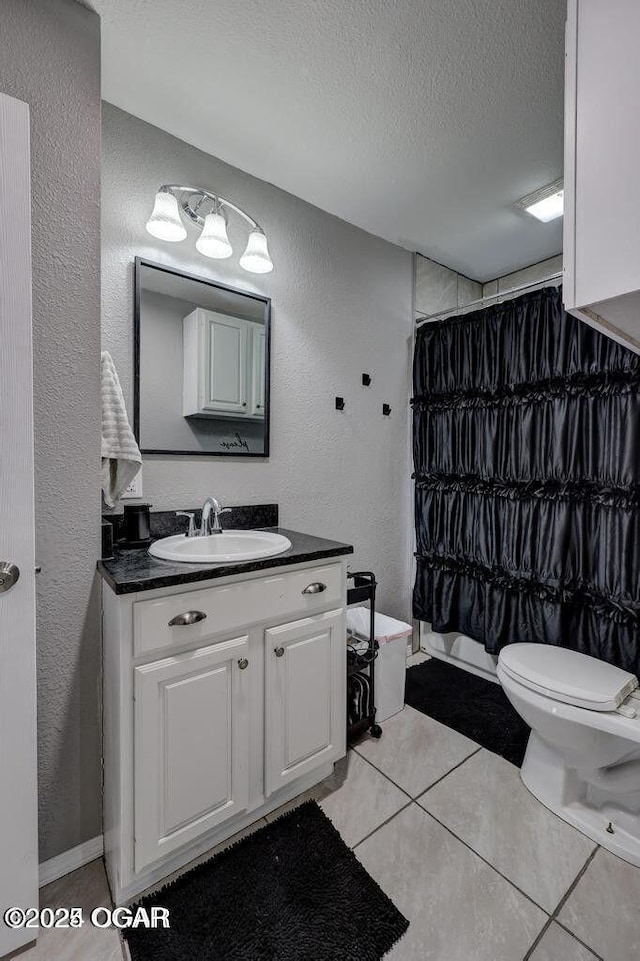 bathroom featuring tile patterned floors, toilet, a textured ceiling, vanity, and a shower with shower curtain