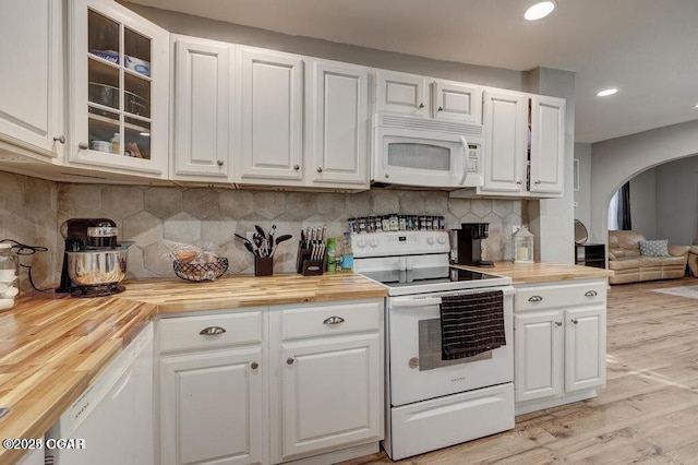 kitchen featuring white appliances, wood counters, and white cabinets