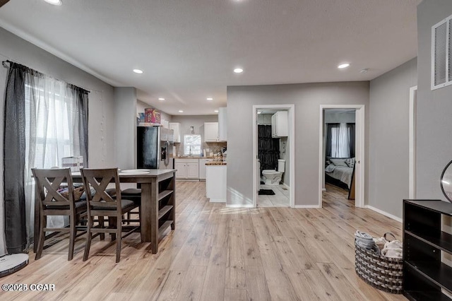 dining space featuring plenty of natural light and light hardwood / wood-style floors