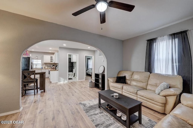 living room featuring ceiling fan and light wood-type flooring