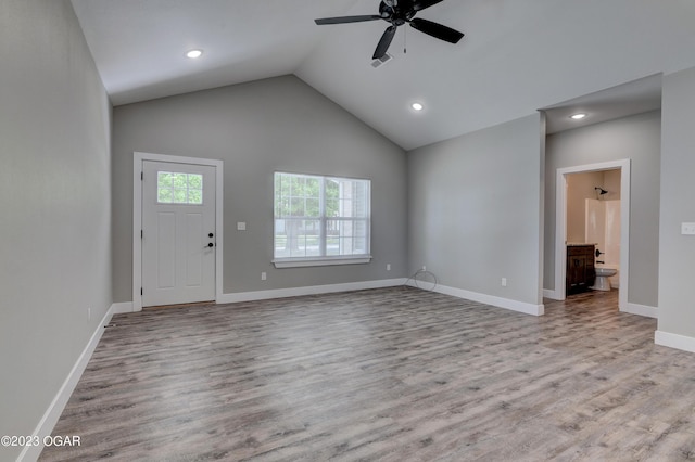 unfurnished living room with ceiling fan, lofted ceiling, and light hardwood / wood-style floors