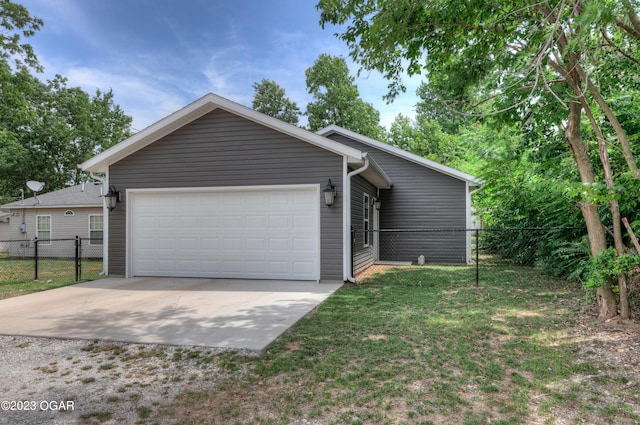 ranch-style house featuring a garage and a front yard