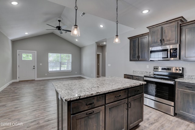 kitchen featuring dark brown cabinets, light hardwood / wood-style flooring, a kitchen island, pendant lighting, and stainless steel appliances