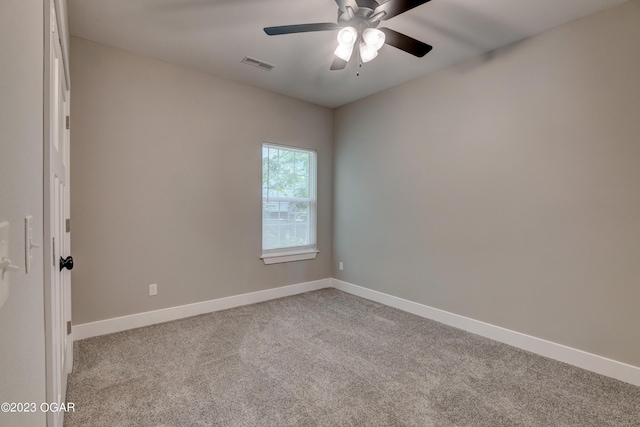 carpeted empty room featuring ceiling fan