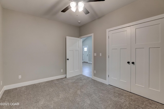 unfurnished bedroom featuring light carpet, a closet, and ceiling fan