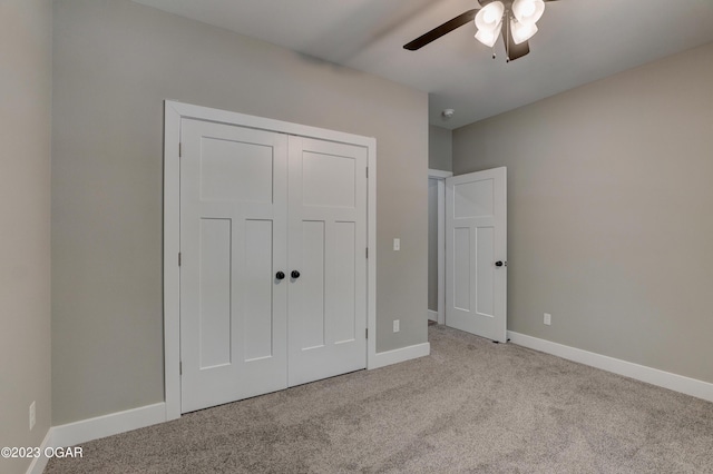 unfurnished bedroom featuring light colored carpet, a closet, and ceiling fan