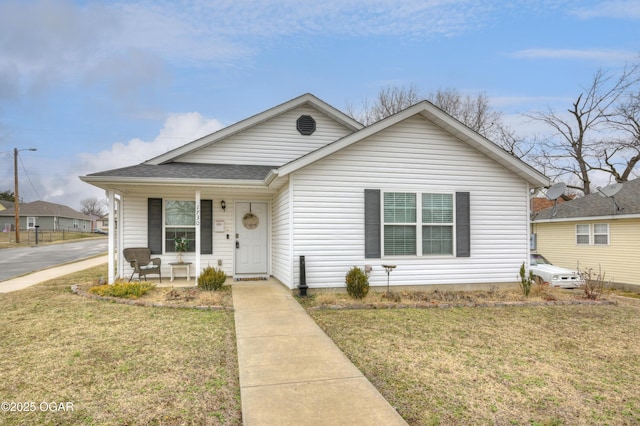 bungalow-style house with covered porch and a front lawn