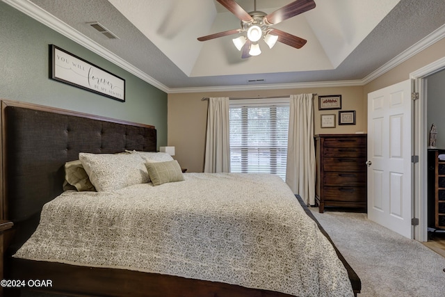 carpeted bedroom featuring a raised ceiling, ornamental molding, ceiling fan, and a textured ceiling