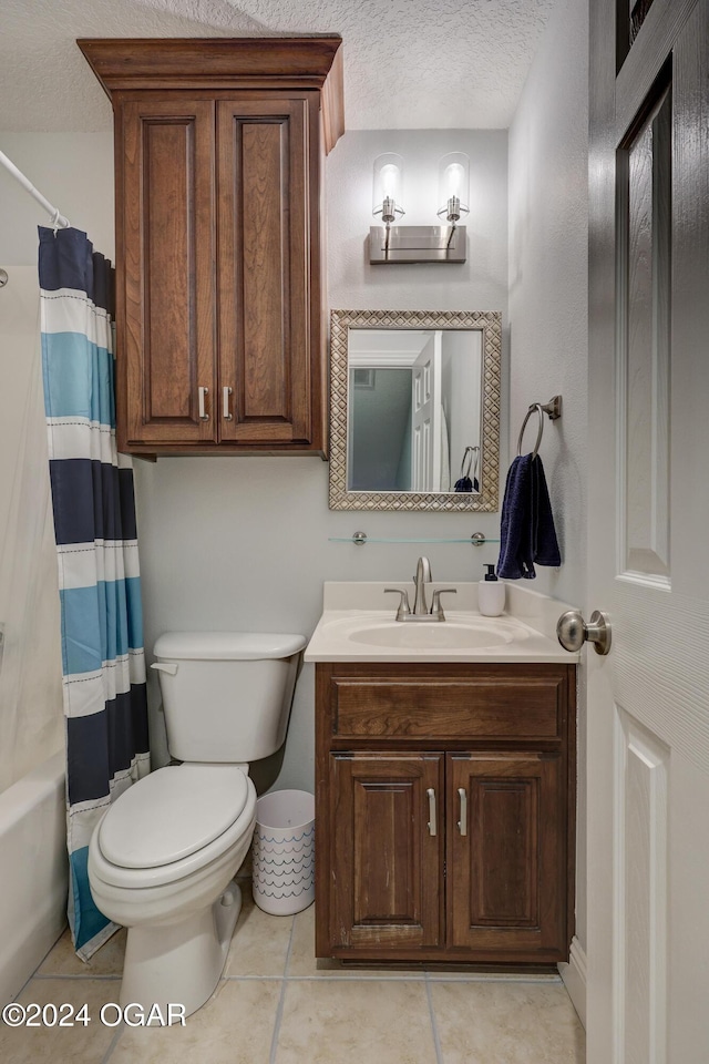 full bathroom featuring shower / tub combo with curtain, tile patterned flooring, vanity, toilet, and a textured ceiling