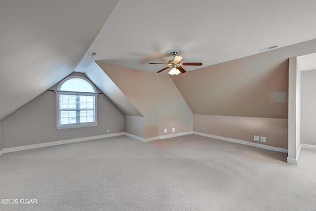 additional living space with ceiling fan, light colored carpet, and lofted ceiling