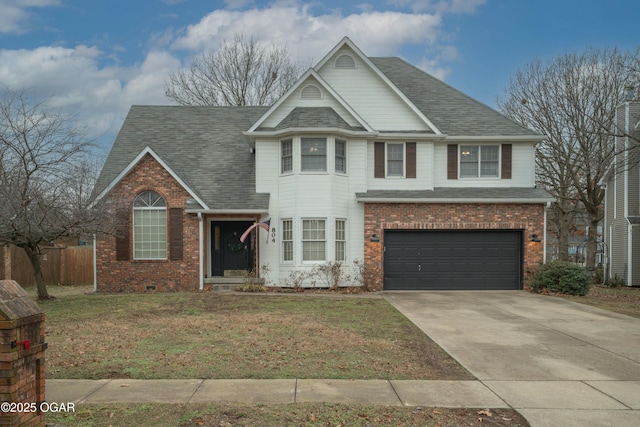 view of front of property featuring a garage and a front yard