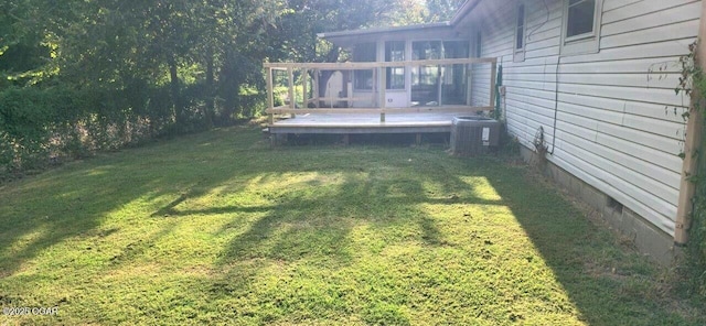 view of yard featuring central AC and a deck