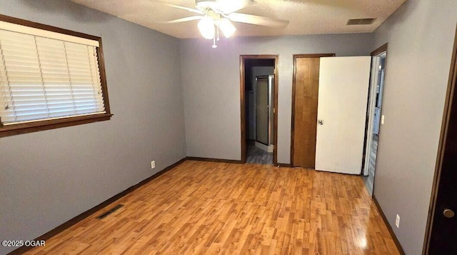 unfurnished bedroom with ceiling fan and light hardwood / wood-style flooring