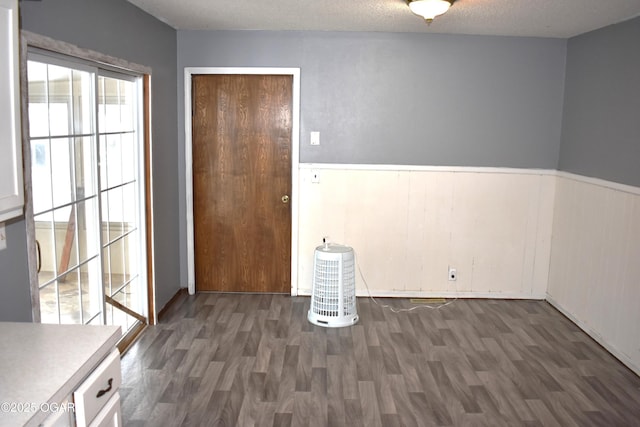 interior space with dark wood-type flooring and a textured ceiling