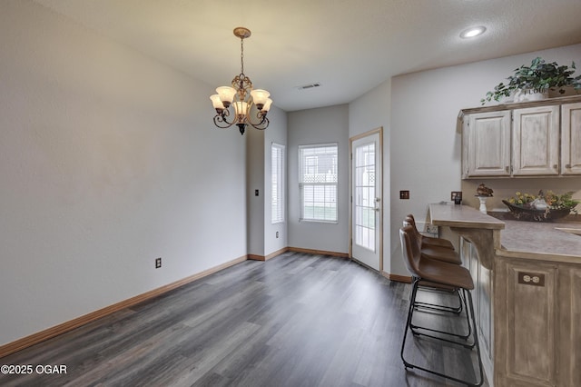 dining room featuring a notable chandelier, recessed lighting, baseboards, wood finished floors, and visible vents