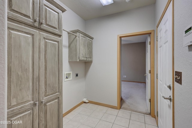 laundry area featuring baseboards, hookup for an electric dryer, cabinet space, light tile patterned floors, and washer hookup