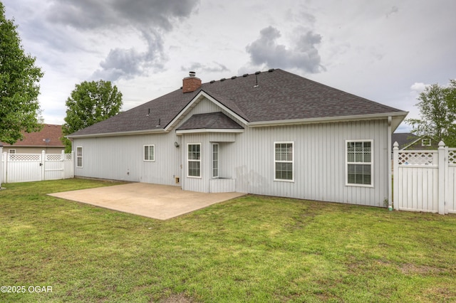 rear view of house featuring roof with shingles, fence, a chimney, and a patio area