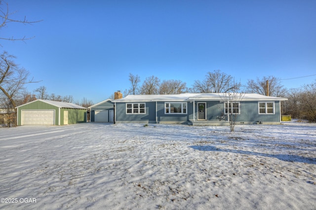 ranch-style house featuring an outbuilding and a garage