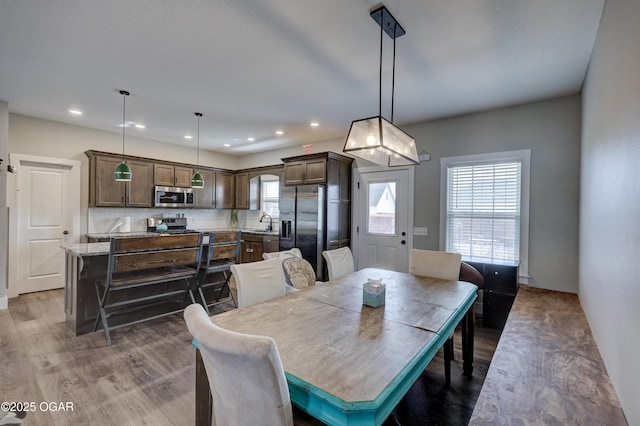 dining area featuring sink and dark hardwood / wood-style floors