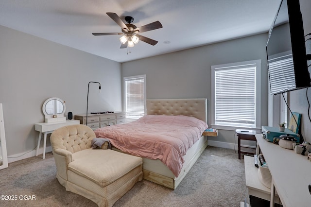 bedroom with ceiling fan and light carpet