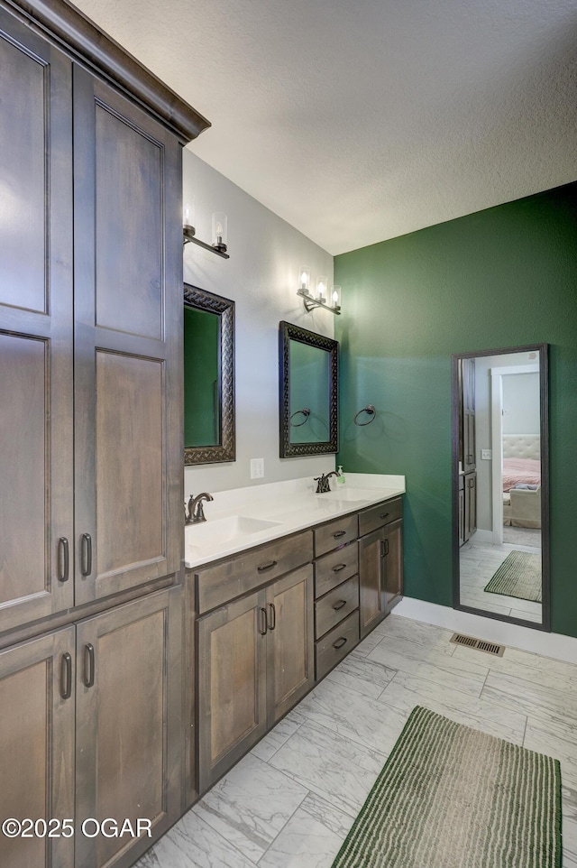 bathroom featuring vanity and a textured ceiling