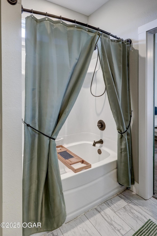 bathroom featuring shower / bathtub combination with curtain