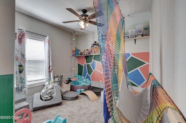 recreation room with ceiling fan and carpet floors