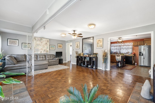 living room featuring ceiling fan and dark parquet flooring