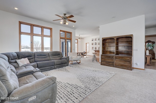 carpeted living room with ceiling fan and a healthy amount of sunlight