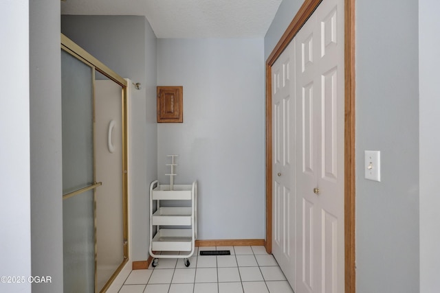 interior space with light tile patterned floors and a textured ceiling