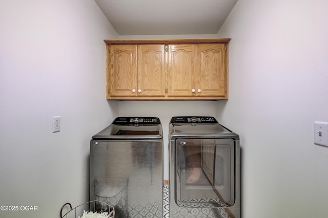 laundry area with cabinets and washing machine and clothes dryer