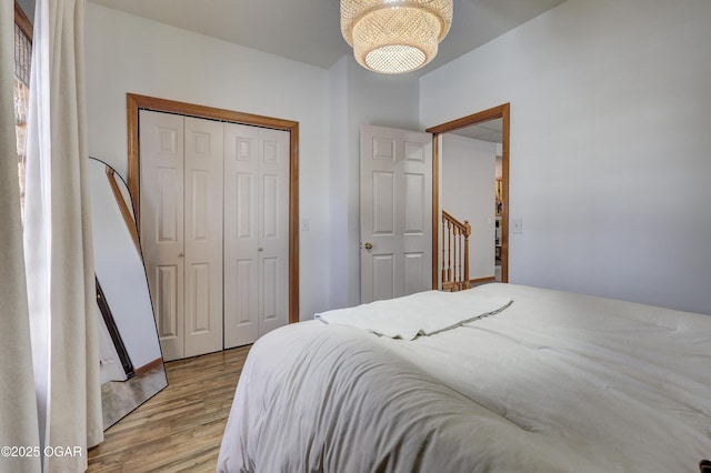 bedroom with light wood-type flooring and a closet