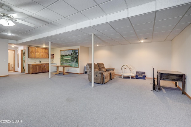 interior space with light carpet, sink, and a drop ceiling