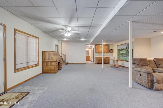 interior space featuring a paneled ceiling and ceiling fan