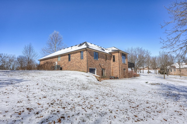 view of snow covered back of property