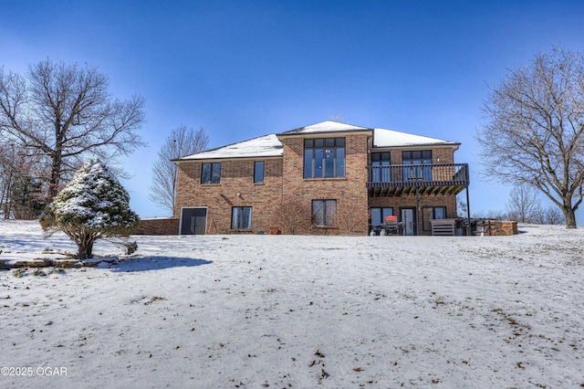 snow covered property with a deck