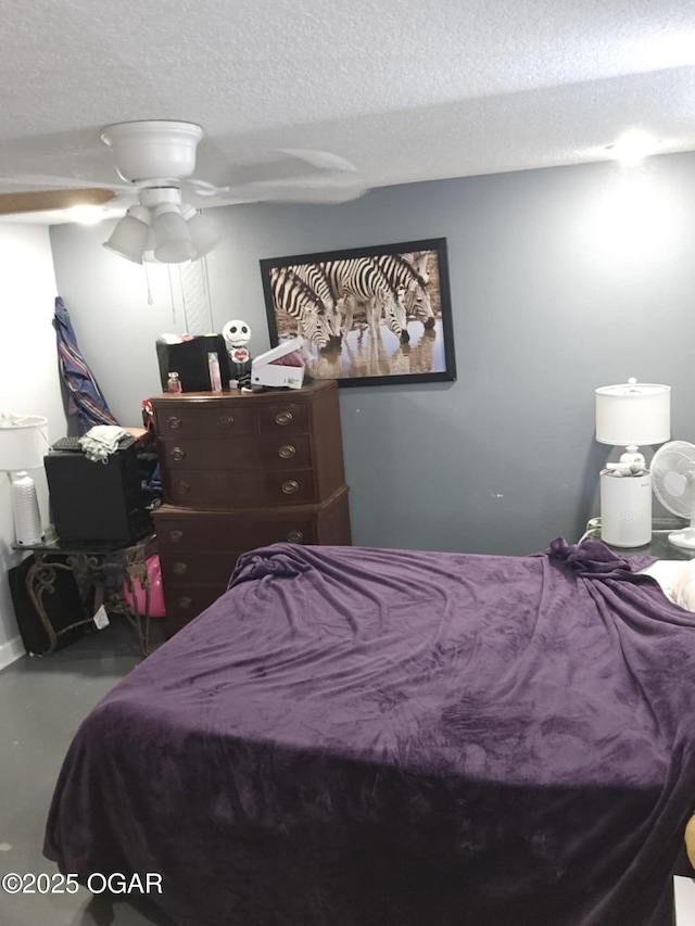 bedroom with a textured ceiling, ceiling fan, and concrete floors