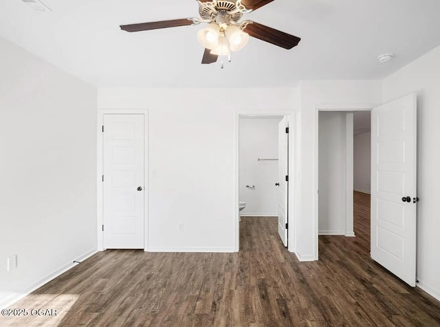 unfurnished bedroom with a ceiling fan, dark wood-style flooring, and baseboards