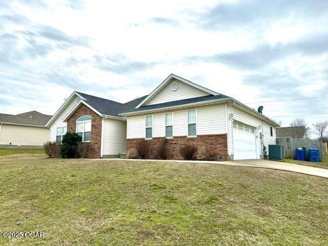 single story home with a garage, central AC, and a front lawn