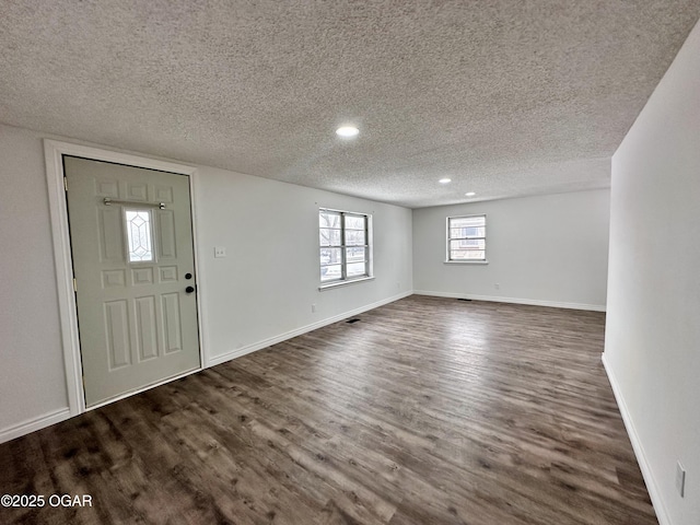 foyer with dark hardwood / wood-style floors and a textured ceiling