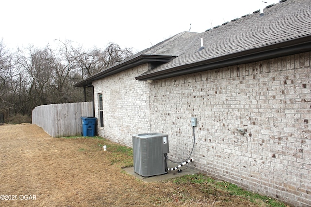 view of side of home with central AC unit