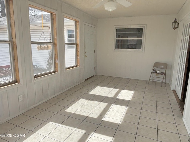 spare room featuring light tile patterned floors and ceiling fan