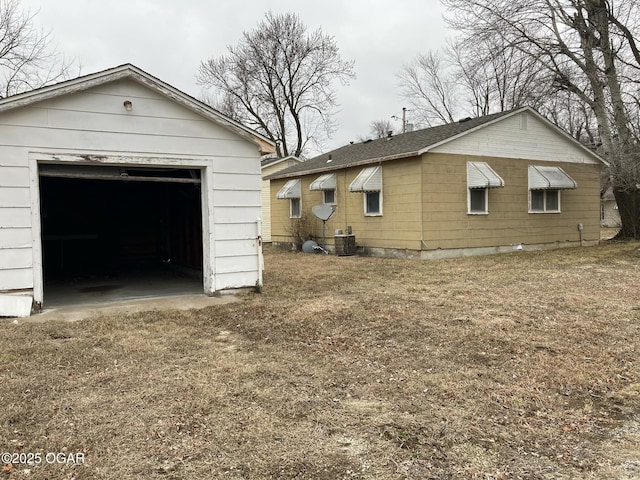 exterior space featuring an outbuilding, a garage, and central AC