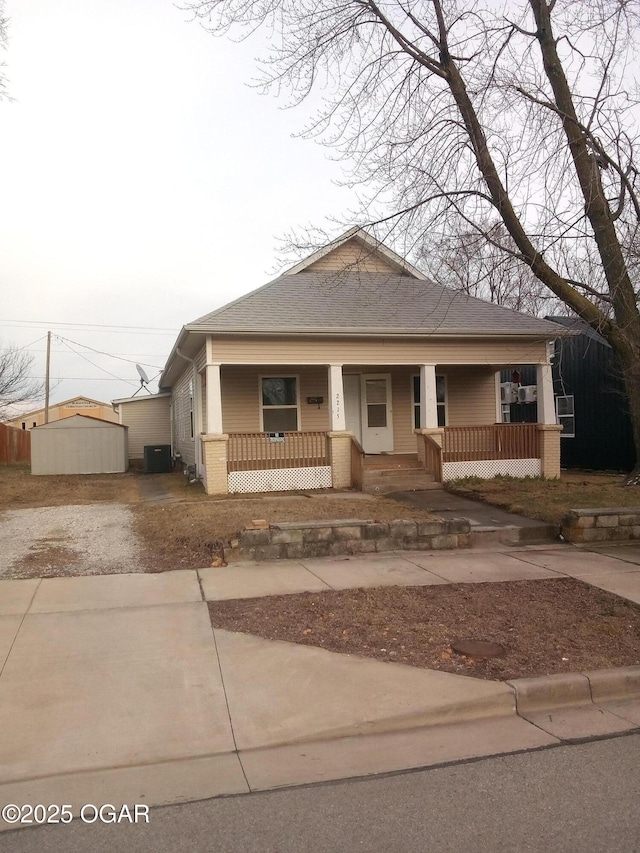 view of front of home with central AC unit and a porch