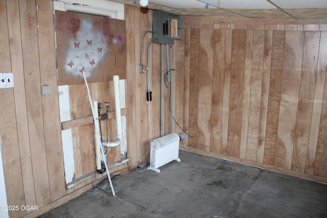 interior space with electric panel and wooden walls