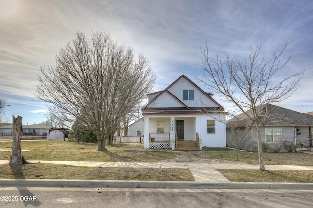 bungalow-style house with a porch and a front yard