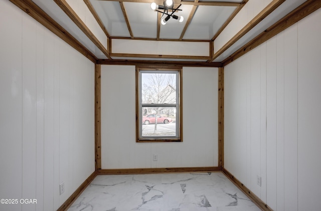 unfurnished room featuring marble finish floor and baseboards