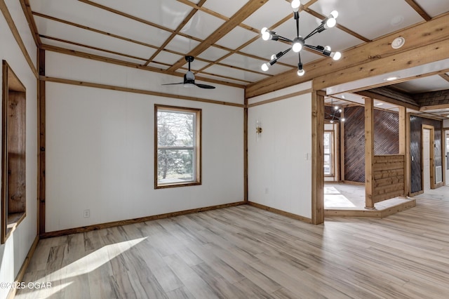 empty room featuring light wood finished floors and baseboards