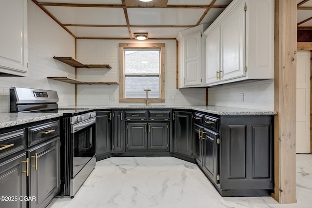 kitchen with tasteful backsplash, white cabinets, marble finish floor, stainless steel electric stove, and a sink